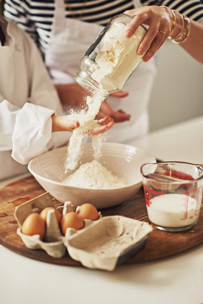 Recipe_Areias_parent-hands-child-with-flour-bake-kitchen-growth-development-helping-teaching-family-home-pouring-mom-kid-learning-pastry-recipe-bonding-cooking-food-dessert Sofia’s recipe for Areias de Cascais